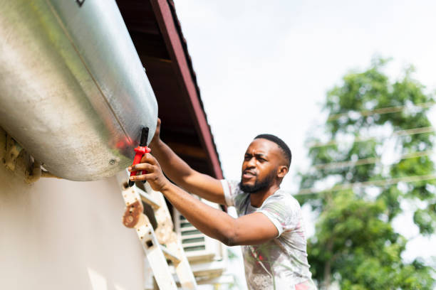 close up man using trying tools to fix hot water geyser