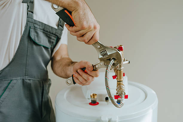 man fixing water heater. close up view of male hands using wrench.